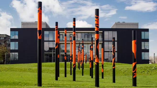 Color photo of the CRC building with sculptures on the lawn